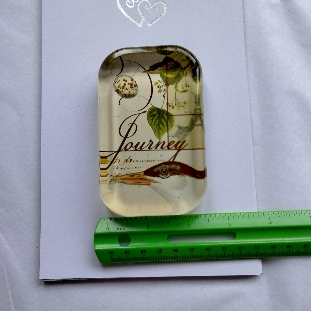 Glass paperweight with bird journey theme